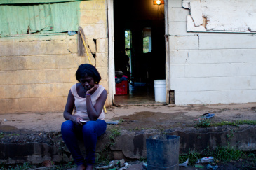 Juliana Deguis Pierre sits outside her home in the Dominican Republic.
